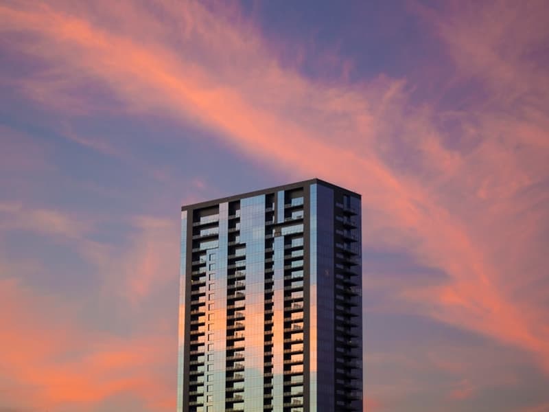 Downtown Austin homes - High-Rise Condos, Lofts, Townhomes, Luxury Penthouses Modern downtown condo building lobby or exterior, sleek urban living in Downtown Austin